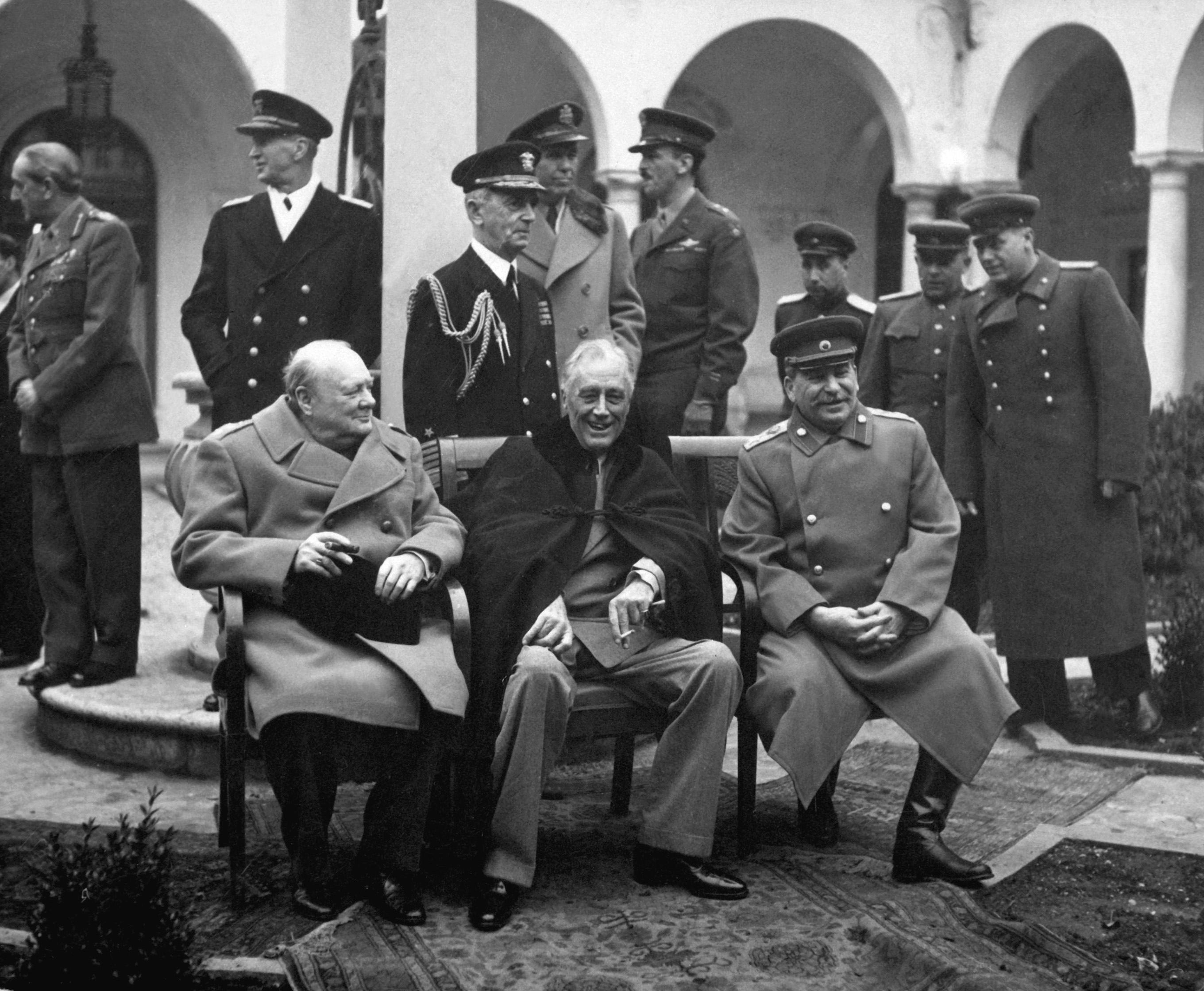 Moment image for World War II strategy meeting between Allies, Churchill, Stalin, and Roosevelt in Tehran.