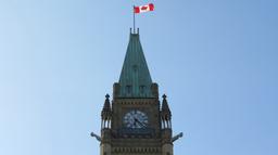 Canadian Parliament adopts new national flag design featuring red maple leaf symbol.