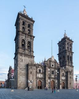 Inauguration of Puebla Cathedral fusing Spanish and indigenous architectural designs for a unique structure.