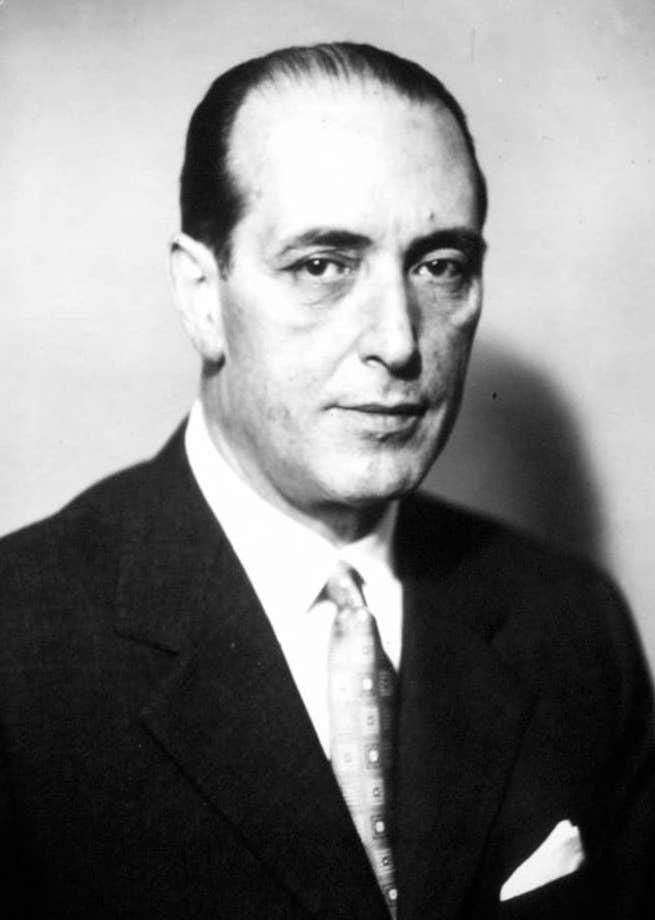 Moment image for Controversial leadership: Fernando Tambroni's brief term as Prime Minister sparks protests and criticism.