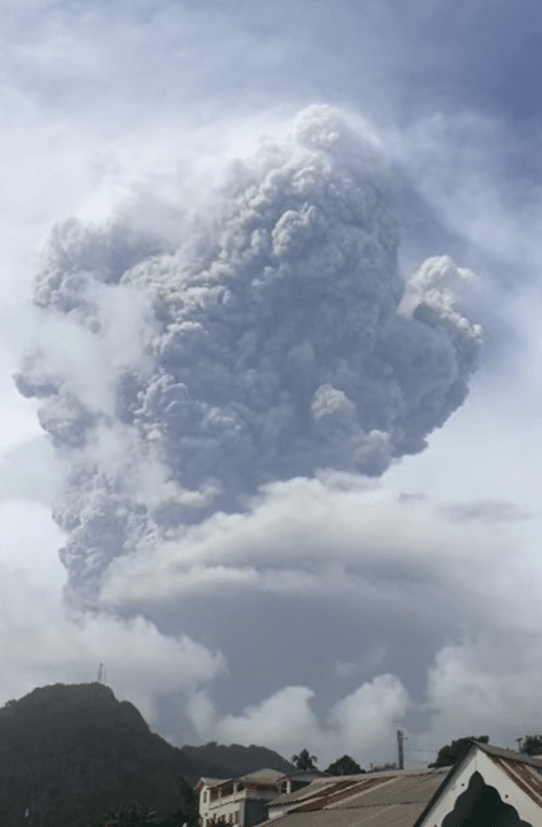 Moment image for La Soufrière volcano erupts, causing extensive ash fall in Barbados, prompting cleanup and aid efforts.