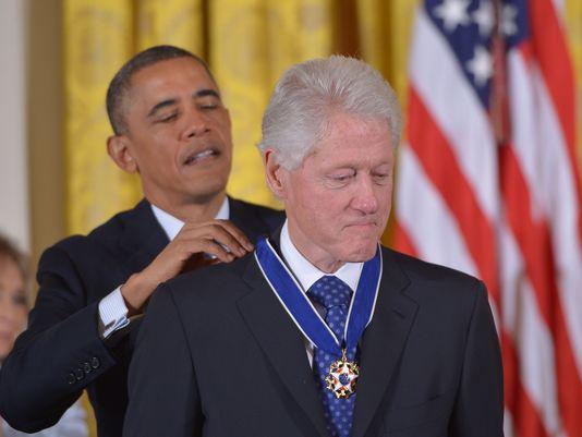 Moment image for Awarded the Presidential Medal of Freedom: Barack Obama honors Bill Clinton.