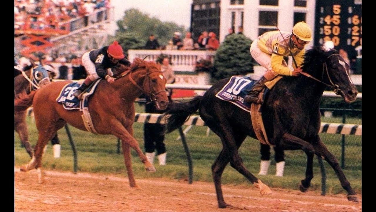 Moment image for Sunday Silence wins in muddy conditions under Pat Valenzuela for H-G-W Partners.