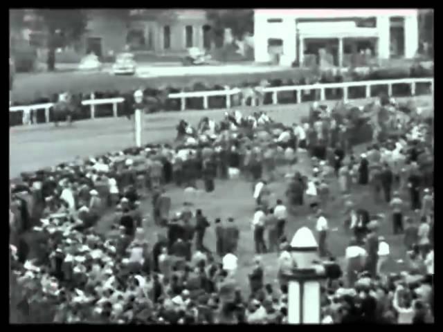 Moment image for Count Turf wins with jockey Conn McCreary in 1+1⁄4 miles race at fast track.