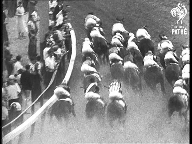 Moment image for Burgoo King wins 1+1⁄4 miles race on fast track in 2:05.2 with Eugene James.