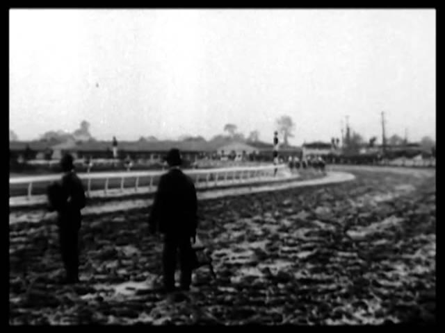 Moment image for Exterminator clinches victory in muddy conditions, with Willie Knapp, Henry McDaniel, and Willis Sharpe Kilmer.