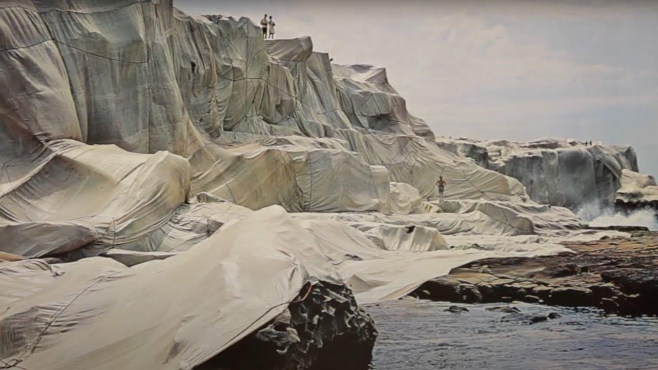 Moment image for Christo wraps Little Bay beach in Sydney with yellow hues.