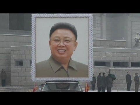 Moment image for Transition in North Korean leadership after Kim Jong Il's death, marked by mourning and international concern.