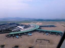 Incheon International Airport opening on tidal land off port.